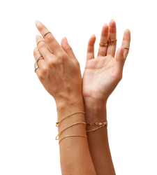 Hands wearing fine gold bracelets and rings