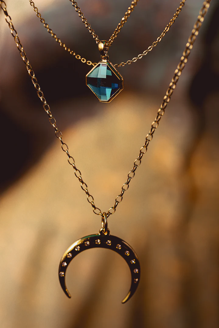 Two layered gold necklaces with pendants